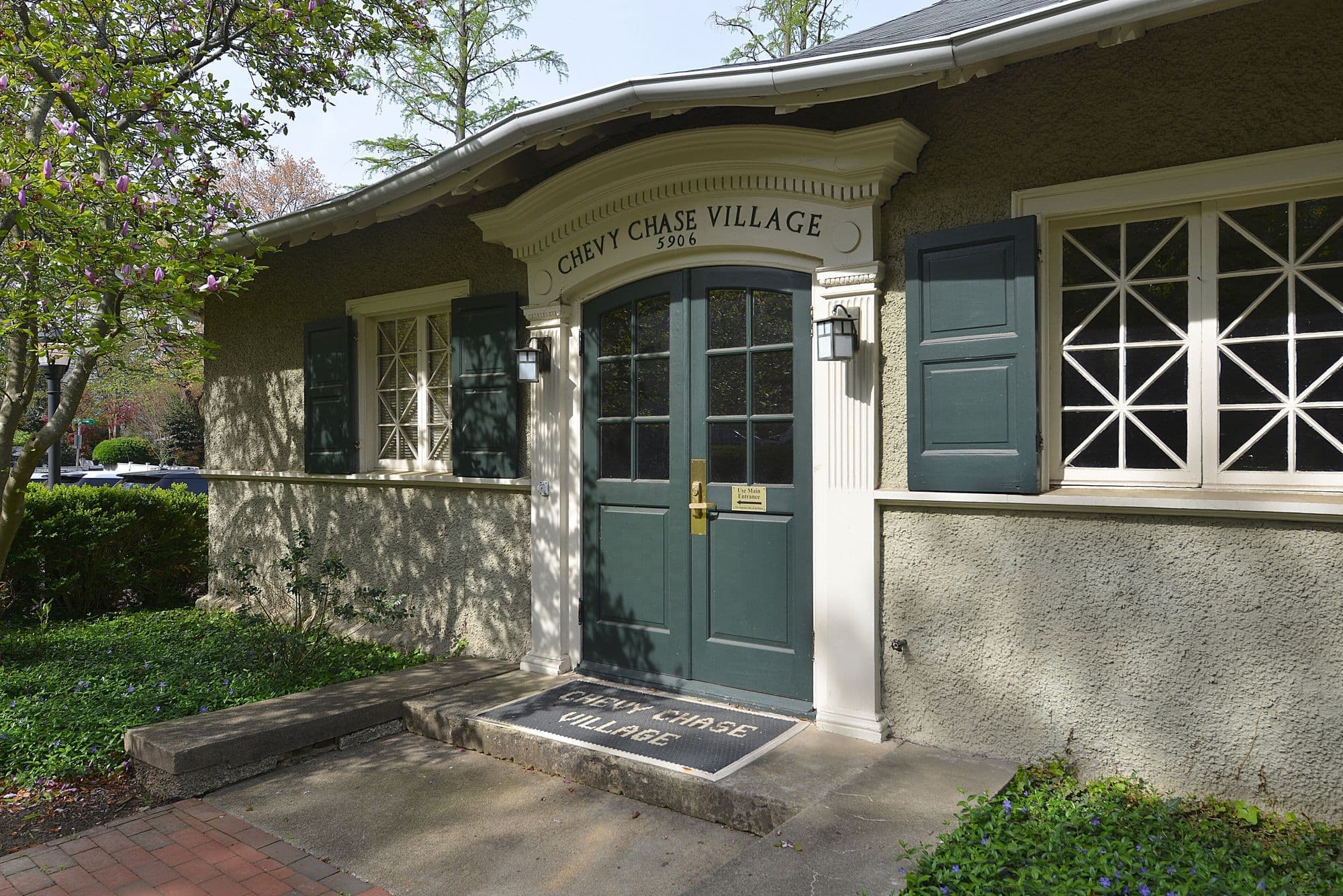 The Chevy Chase Village Hall on Connecticut Avenue in Chevy Chase, Maryland, with a magnolia tree in bloom